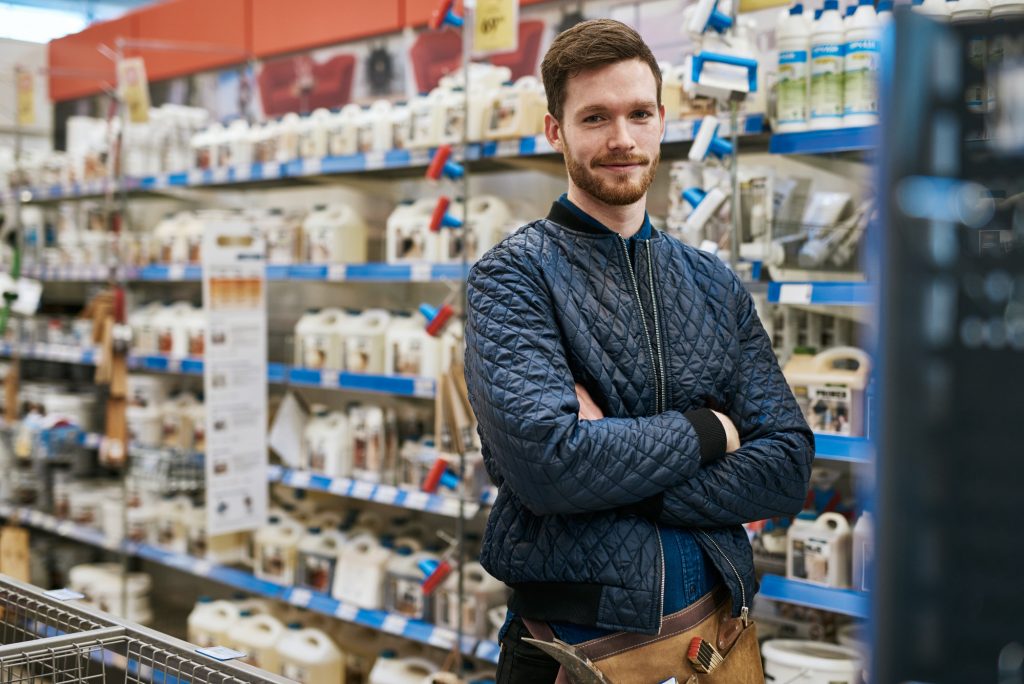 Confident handyman in a hardware store